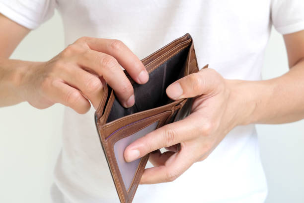 istock The young man's hand opened his wallet without money. 1392251935