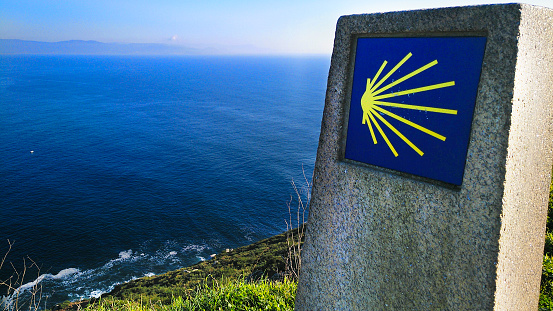 Atlantic ocean and cliff view, Camino de Santiago end milestone at Finisterre cape. A Coruña province, Galicia, Spain.  Pilgrimage route,   UNESCO world heritage .