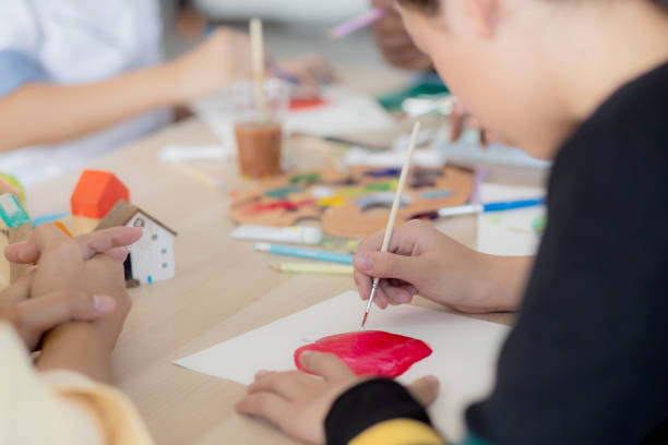 istock Closeup group of student sitting and studying and learning drawing with teacher together in classroom at the school, pupils creativity for drawing in course, back to school, education concept. 1392255647