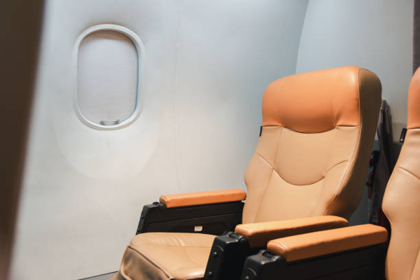 istock Empty aircraft seats and windows, passenger seat interior airplane 1392255814