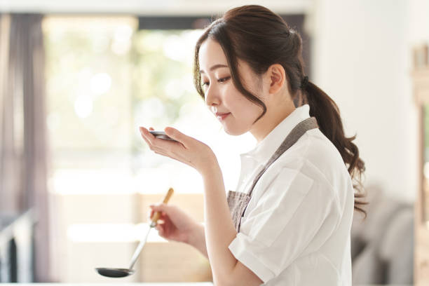 Asian woman cooking in the kitchen Asian woman cooking in the kitchen japanese chef stock pictures, royalty-free photos & images