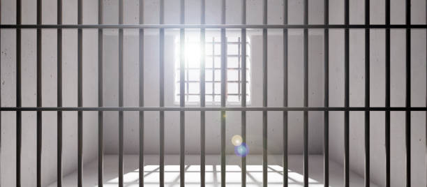 istock Prison cell with window, jail steel bars and concrete walls, empty dungeon interior. 3d render 1392262188