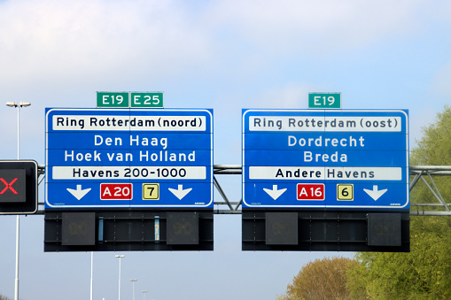 Blue Direction sign for the directions on Motorway A20 for directions A16 Dordrecht and A20 Hoek van Holland and The Hague in the Netherlands.