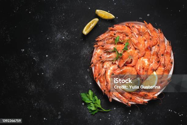 Boiled Tiger Prawns In A Plate On A Black Stone Background Red Shrimp Top View Flat Lay Stock Photo - Download Image Now