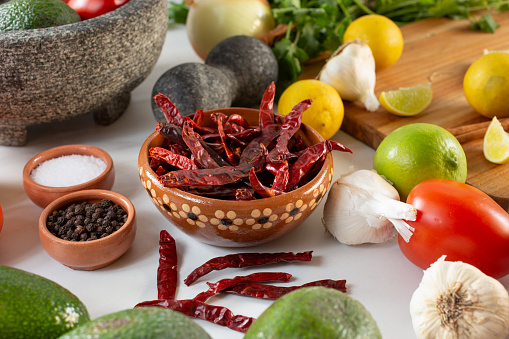 A view of a bowl of dried chile de arbol, among other salsa ingredient.