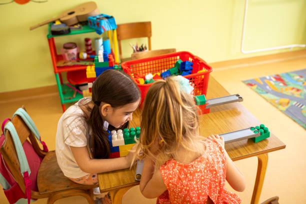 Preschool girls playing together during class, making a strong friendship stock photo