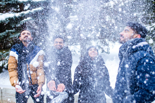 istock group of four indian having fun playing in snow outdoors spending Chrisymas holidays 1392274248