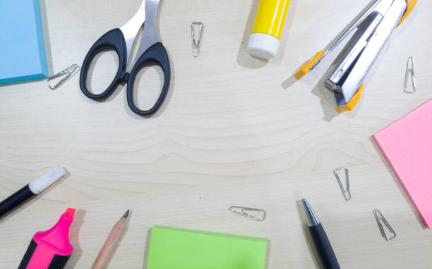 istock Some office stationery on wooden table, with center copy space 1392275562