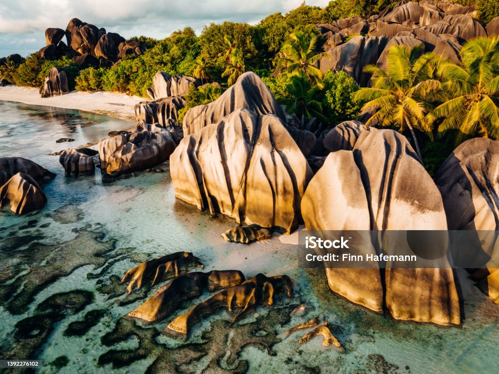 Anse Source d'Argent Beach La Digue Island Seychelles La Digue Anse Source d'Argent Beach. Drone view over the famous Anse Source d'Argent Beach with it’s famous granite boulder rock formations and crystal clear ocean on La Digue Island in warm sunset light. La Digue Island, Seychelles Islands, East Africa Seychelles Stock Photo