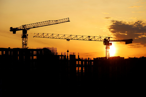 Housing construction, apartment block in city on dramatic sky background