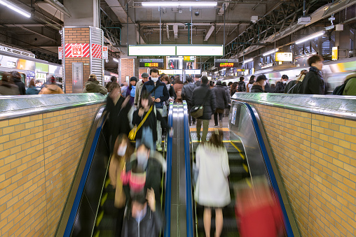 Tokyo, Japan - February 17, 2019: Passengers on JR Yamanote Line Ebisu Station platform at night.