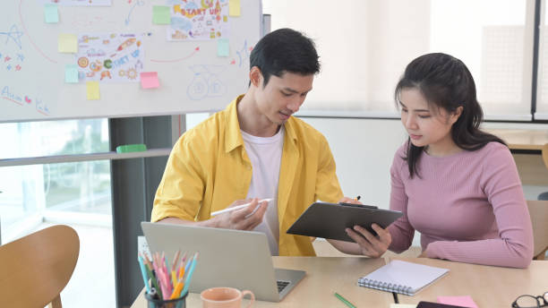 istock Young creative people are sharing ideas and discussing startup business plan together. 1392280627