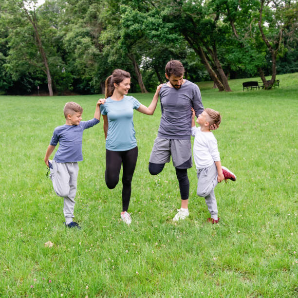 istock Family doing stretching exercises in nature. 1392280910