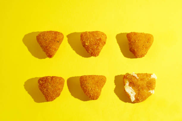 istock Pattern of deep-fried camembert on yellow background 1392284203