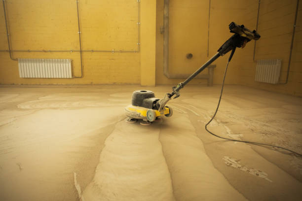 istock Concrete floor grinding. Construction process. Sanding a concrete floor with a sander in a warehouse 1392284503