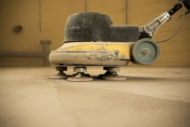 istock Concrete floor grinding. Construction process. Sanding a concrete floor with a sander in a warehouse 1392284509