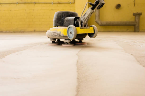 istock Concrete floor grinding. Construction process. Sanding a concrete floor with a sander in a warehouse 1392284519