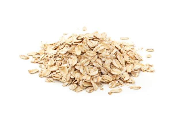 istock Pile of oat flakes isolated on white background 1392285946