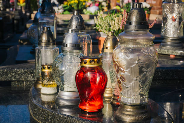 istock Catholic cemetery background. All saints holiday. Grave candle light. Halloween on graveyard. Grave candles on marble tomb. 1392286002