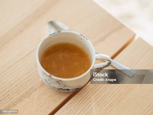 Chicken Bone Broth In A Cup With Spoon Stock Photo - Download Image Now - Bone Broth, Broth, Bone