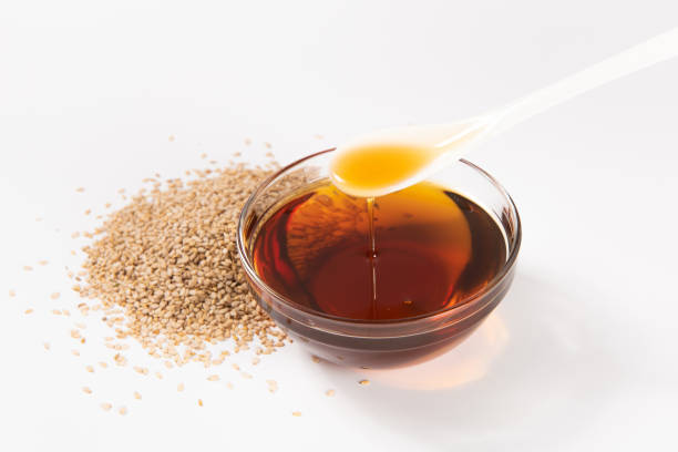 istock Sesame seeds and sesame oil on white background 1392288937