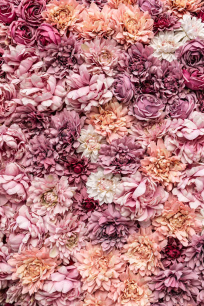 istock Flowers as background. Pink artificial flowers. 1392291788