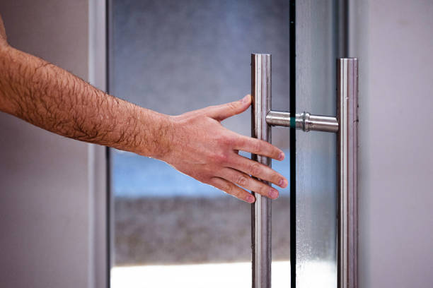 istock Man opening a glass door 1392293813