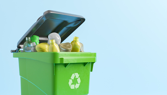 3D illustration of green recycling bin with bunch of various plastic trash against blue background