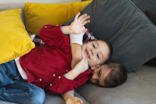 istock Two cute siblings play fighting at home 1392295707