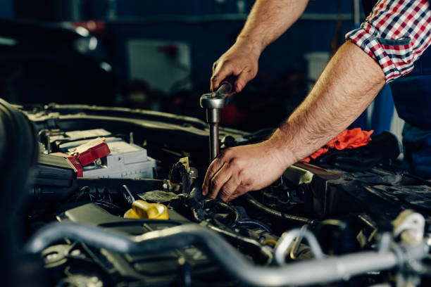 istock Auto mechanic working on car engine in mechanics garage. 1392296759