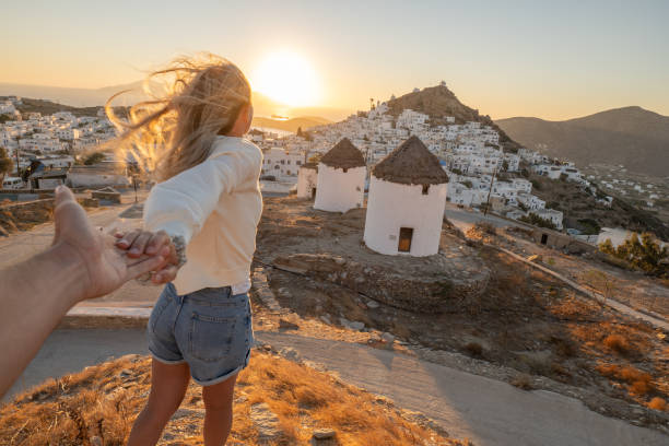 istock Couple holding hands, follow me to Greece 1392298031