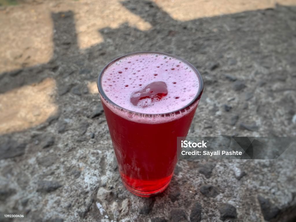 Cranberry juice on the table. Kokam juice. Energy drinks of summer days. Drinking Glass Stock Photo