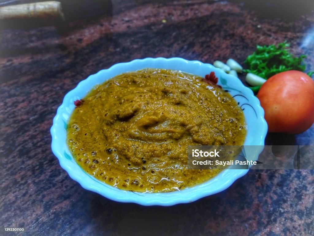 Kokani ( western ghats of maharashta, india ) style fish coconut curry paste it's ingredients; tomato, chilli, garlic and coriander. Asia Stock Photo