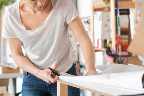 istock Unrecoginzable person cutting cloth. 1392301402