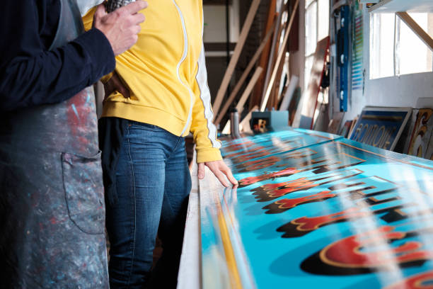 istock A sign-maker is discussing the results with a client. 1392301623