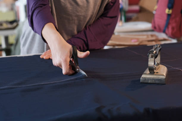 istock A tailor dressmaker in her studio cutting cloth. 1392301673