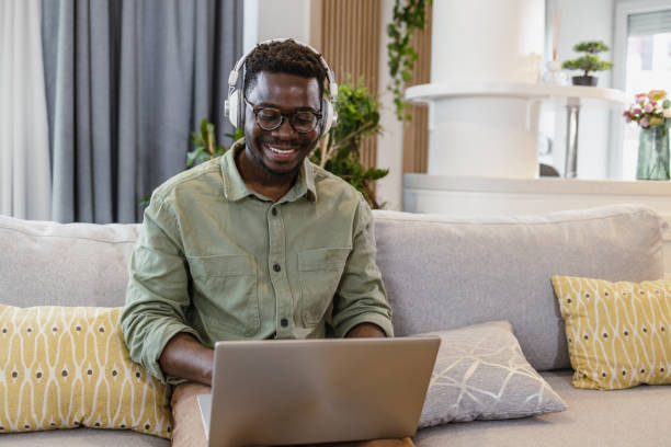 istock Relaxing at home and using laptop in the living room 1392301733