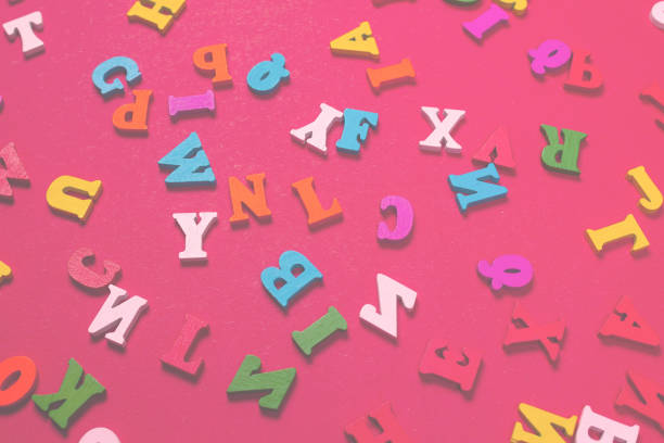 istock Random colorful alphabet on a red background, colorful letters. 1392302455