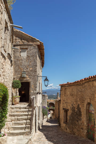 istock Typical for vernacular architecture buildings, constructions, streets of restored old village Lacoste under blue sky, Vaucluse, France 1392303061