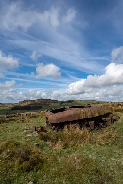 Abandoned Sherman tank in the Peak District National Park at The Roaches, Upper Hulme with Ramshaw Rocks in the distance.