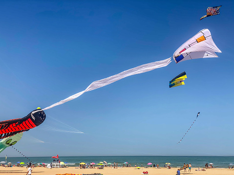 Gandia, Valencian Community, Spain - April 16, 2022: Huge kites floating at the beach as part of an exhibition organized by a local kites association. This is a very touristic town where lots of outdoors activities can be enjoyed