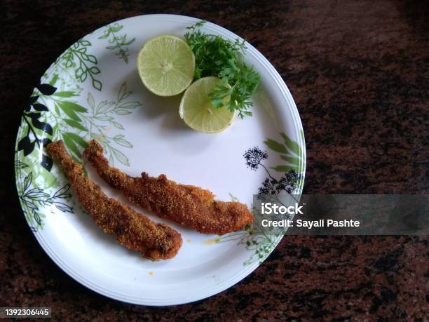 Fried Bombay Duck Fish Or Bombil In A Plate With Lemon And Coriander Famous Food Of Mumbai And Coastal Area Of Maharashta India Stock Photo - Download Image Now