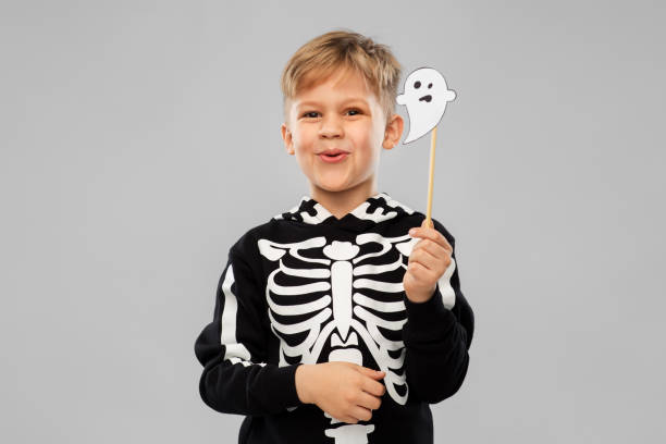 istock boy in halloween costume with ghost decoration 1392306803