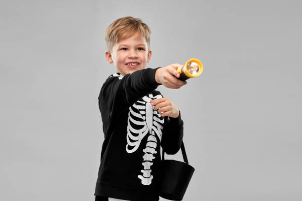 istock boy with candies and flashlight on halloween 1392308070