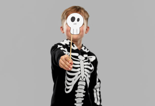 istock boy in halloween costume with scull accessory 1392308283