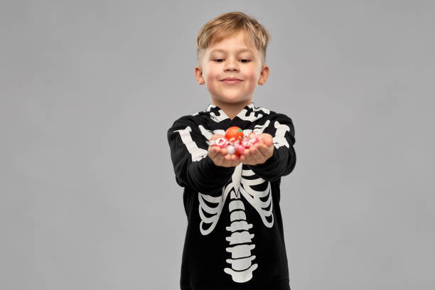 istock boy with candies trick-or-treating on halloween 1392308549
