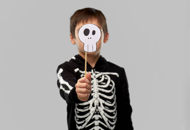 istock boy in halloween costume with scull accessory 1392309411