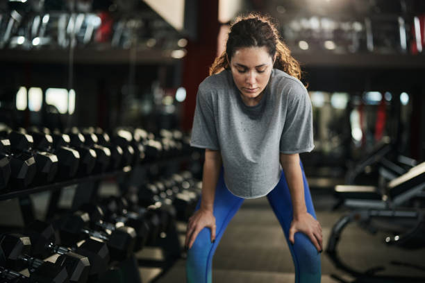 istock Young female athlete resting on a break in a gym. 1392309494