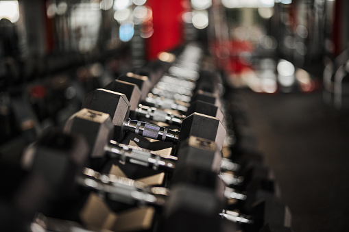 Close up of hand weights on a rack in a gym.