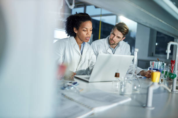 istock Students of science working on laptop in laboratory. 1392311005